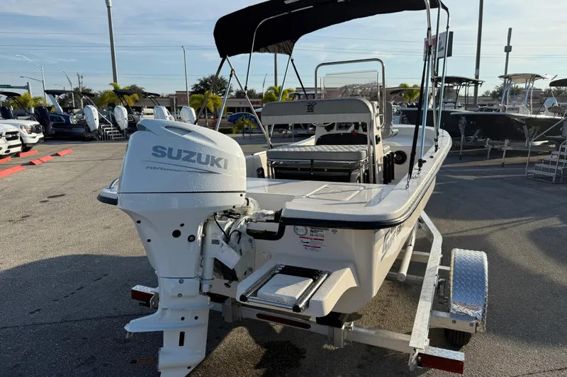 Slide: The Image of 2026 Carolina Skiff E16 JVX CC boat with Suzuki outboard motor on trailer. - 8