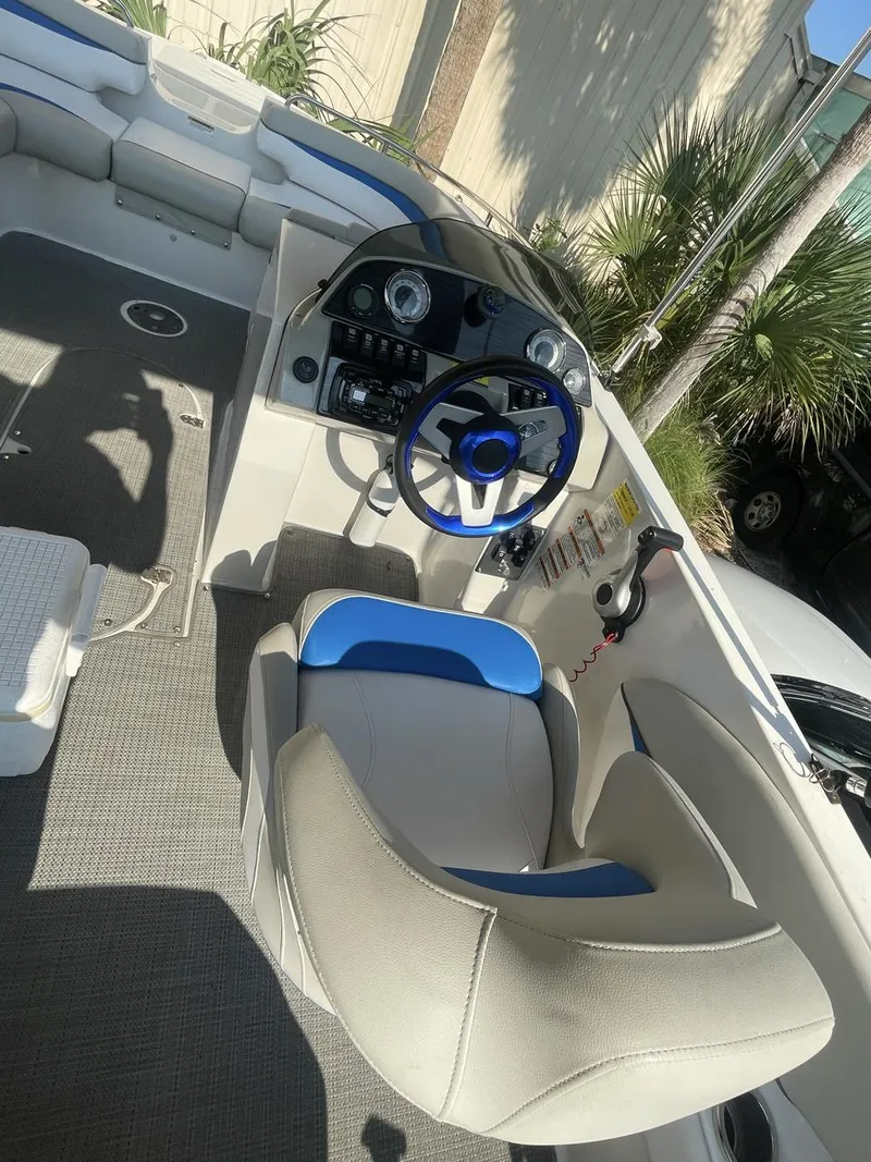 Slide: The Image of 2017 Starcraft MDX 211 O/B boat interior with steering wheel and seating. - 1