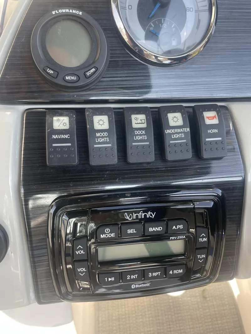 Slide: The Image of Control panel of 2017 Starcraft MDX 211 O/B boat with switches and Infinity stereo system. - 4