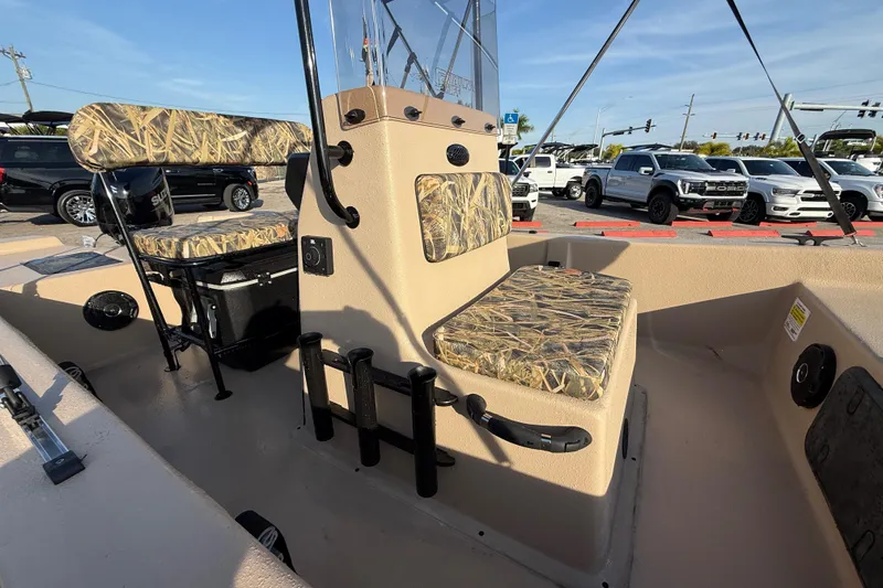 Slide: The Image of 2026 Carolina Skiff E18 JVX CC Sportsman Edition boat interior with camo seating. - 14
