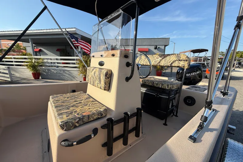 Slide: The Image of 2026 Carolina Skiff E18 JVX CC Sportsman Edition boat interior with camouflage seating. - 17
