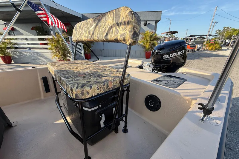 Slide: The Image of 2026 Carolina Skiff E18 JVX CC Sportsman Edition with Suzuki outboard motor, camo seating. - 18