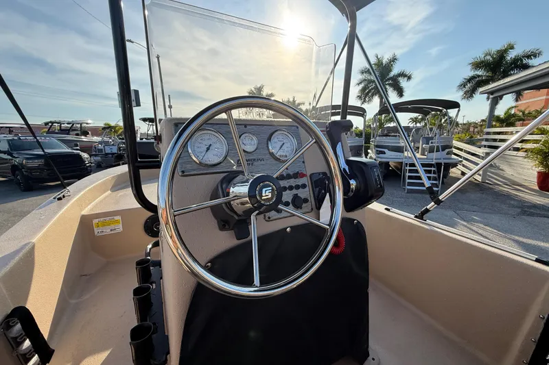 Slide: The Image of 2026 Carolina Skiff E18 JVX CC Sportsman Edition boat dashboard with steering wheel and gauges. - 21