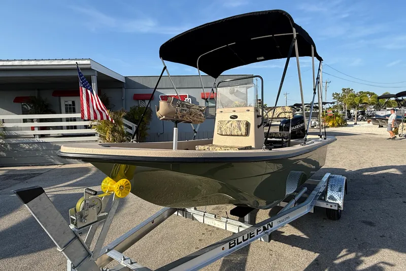 Slide: The Image of 2026 Carolina Skiff E18 JVX CC Sportsman Edition boat on trailer, outdoor display. - 3