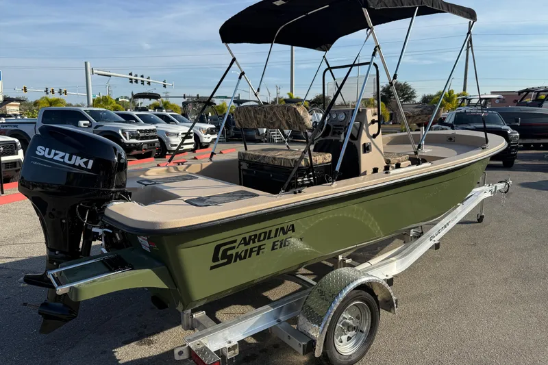 Slide: The Image of 2026 Carolina Skiff E18 JVX CC Sportsman Edition boat on trailer, featuring Suzuki outboard motor. - 6