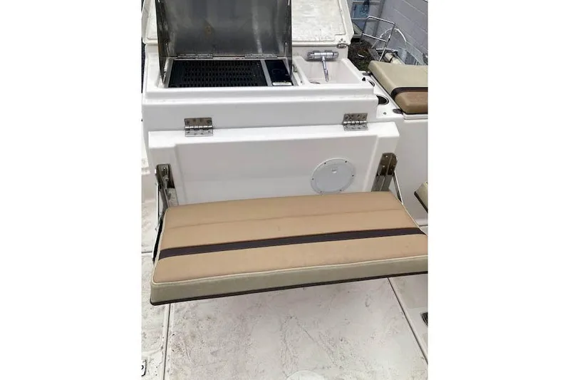 Slide: The Image of 2018 Ranger Tugs R-27 boat interior with foldable seat and compact sink. - 10