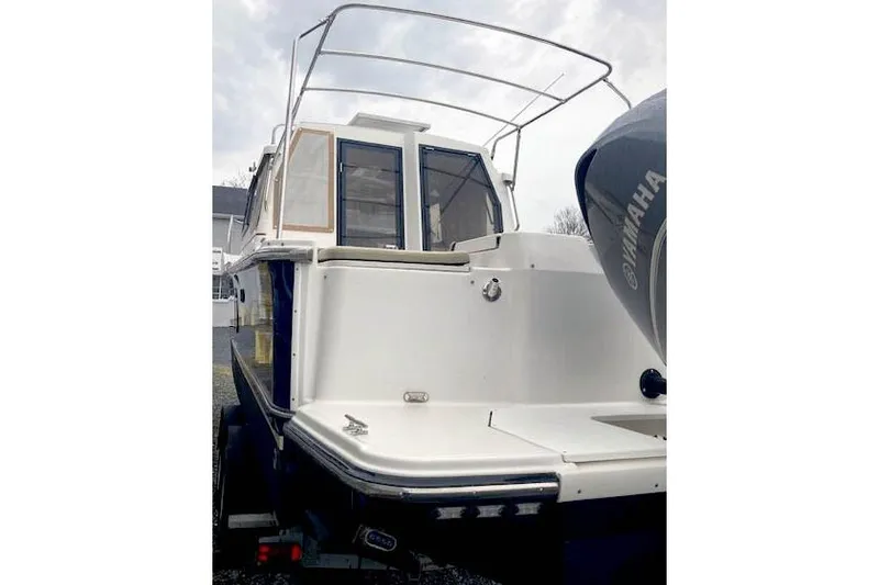 Slide: The Image of 2018 Ranger Tugs R-27 boat rear view with Yamaha outboard motor. - 2