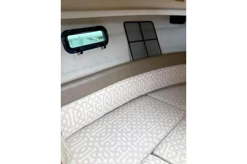 Slide: The Image of Interior cabin of 2018 Ranger Tugs R-27 with patterned seating and window. - 24