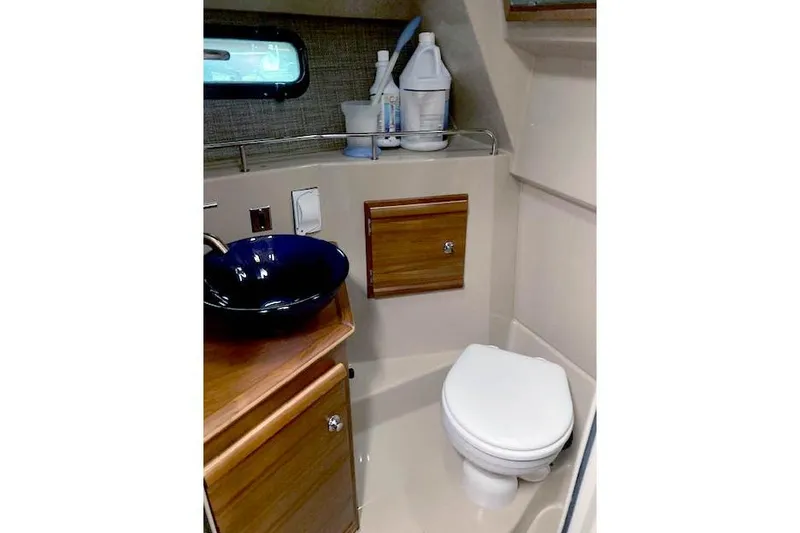 Slide: The Image of 2018 Ranger Tugs R-27 boat bathroom with toilet, sink, and storage cabinet. - 26