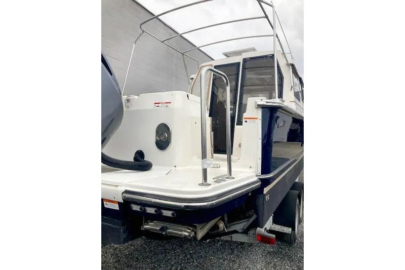 Slide: The Image of 2018 Ranger Tugs R-27 boat, rear view with swim platform and railing. - 3