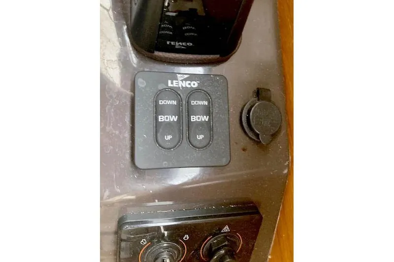 Slide: The Image of Control panel of a 2018 Ranger Tugs R-27 boat with Lenco trim tab switches. - 33