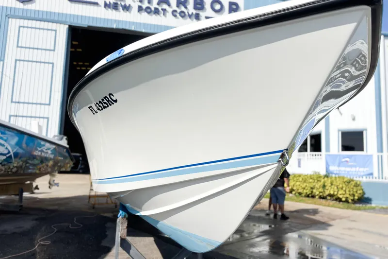 Slide: The Image of 2016 Whitewater boat hull on trailer, outdoor setting with palm trees. - 11