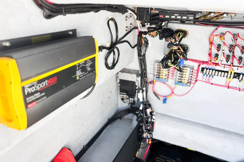 Slide: The Image of Open hatch on a 2016 Whitewater boat, revealing interior wiring and equipment. - 22