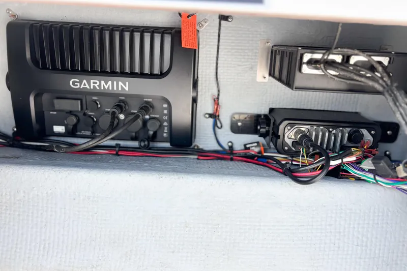 Slide: The Image of Battery compartment of a 2016 Whitewater boat with wiring and life jackets. - 25