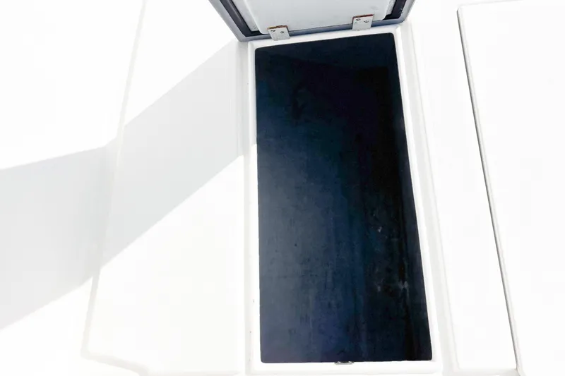 Slide: The Image of Open hatch on 2016 Whitewater boat deck, revealing storage compartment. - 28