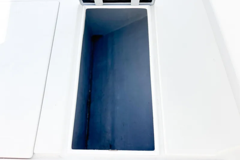 Slide: The Image of Open storage compartment on a 2016 Whitewater boat, showing interior space. - 29