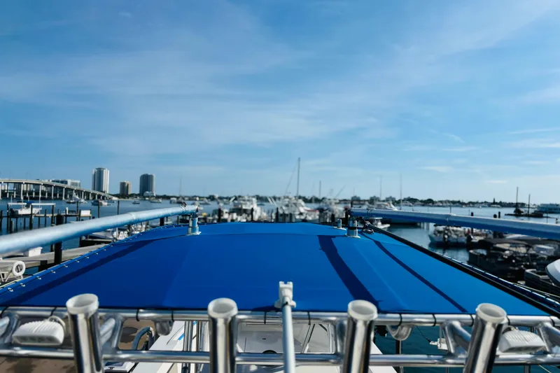Slide: The Image of Blue boat roof with railing, docked at marina, clear sky background. Whitewater, 2016. - 40