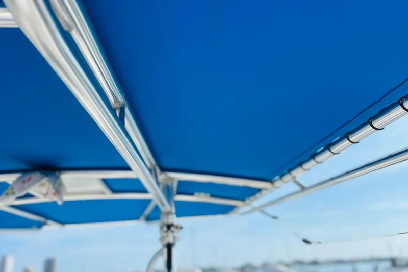 Slide: The Image of Blue boat canopy with metal frame, Whitewater make, 2016 model, clear sky background. - 47