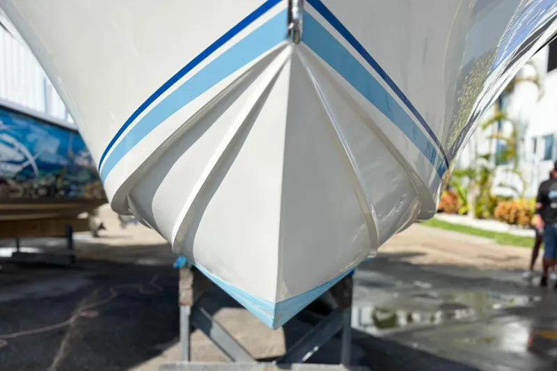 Slide: The Image of Front view of a 2016 Whitewater boat on a stand, with blue stripes. - 9