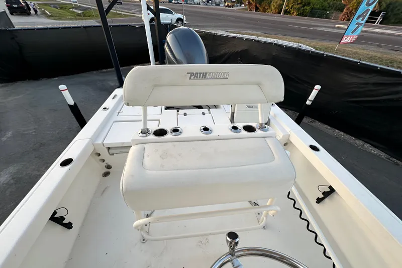 Slide: The Image of 2015 Pathfinder 2200 TRS boat interior with seating and storage compartments. - 13