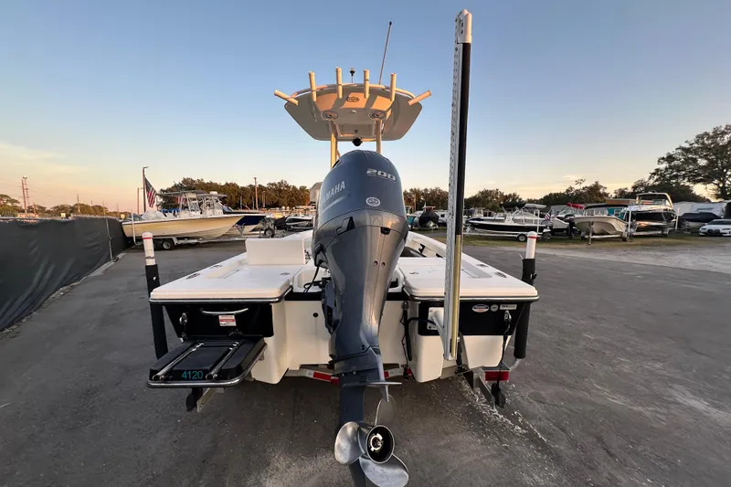 Slide: The Image of 2015 Pathfinder 2200 TRS boat on trailer, featuring Yamaha engine, under clear blue sky. - 2