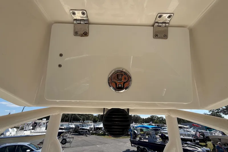 Slide: The Image of 2015 Pathfinder 2200 TRS boat deck with storage compartment in sunlight. - 33