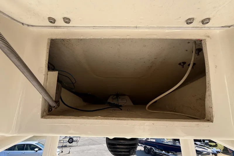 Slide: The Image of Open storage compartment on a 2015 Pathfinder 2200 TRS boat, outdoor setting. - 34
