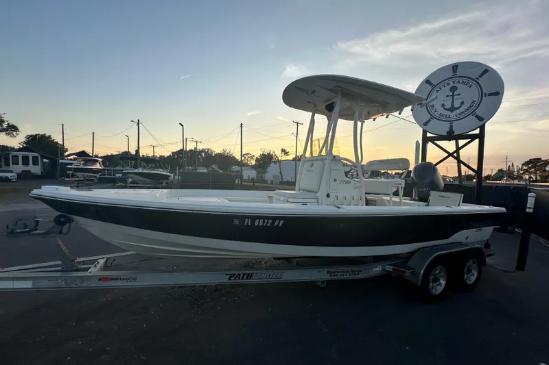Slide: The Image of 2015 Pathfinder 2200 TRS boat with Yamaha 200 engine, docked under blue sky. - 4
