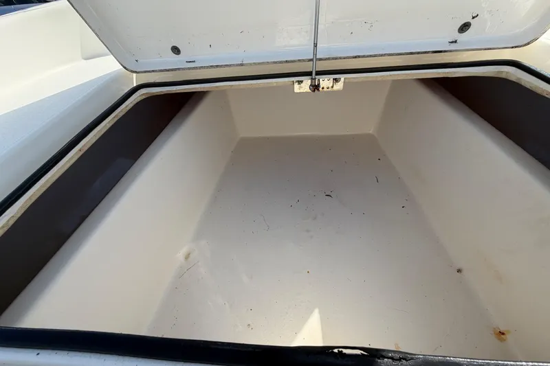 Slide: The Image of 2015 Pathfinder 2200 TRS boat, white deck, center console, parked on pavement. - 46