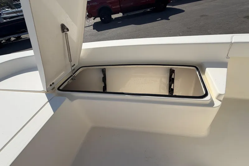 Slide: The Image of 2015 Pathfinder 2200 TRS boat interior, featuring seating and storage compartments. - 48