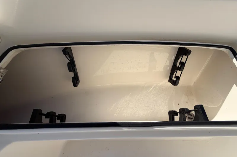 Slide: The Image of 2015 Pathfinder 2200 TRS boat interior with white seating and storage compartments. - 50