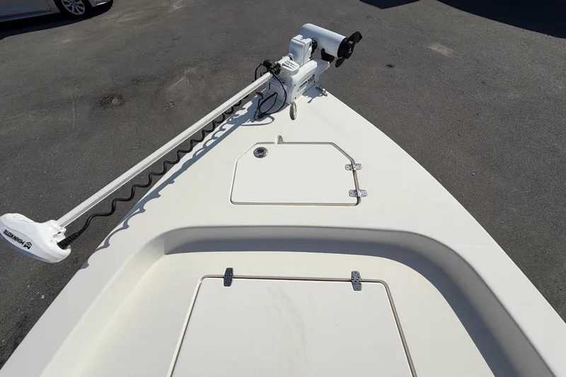 Slide: The Image of 2015 Pathfinder 2200 TRS boat interior with seating and console, parked outdoors. - 51