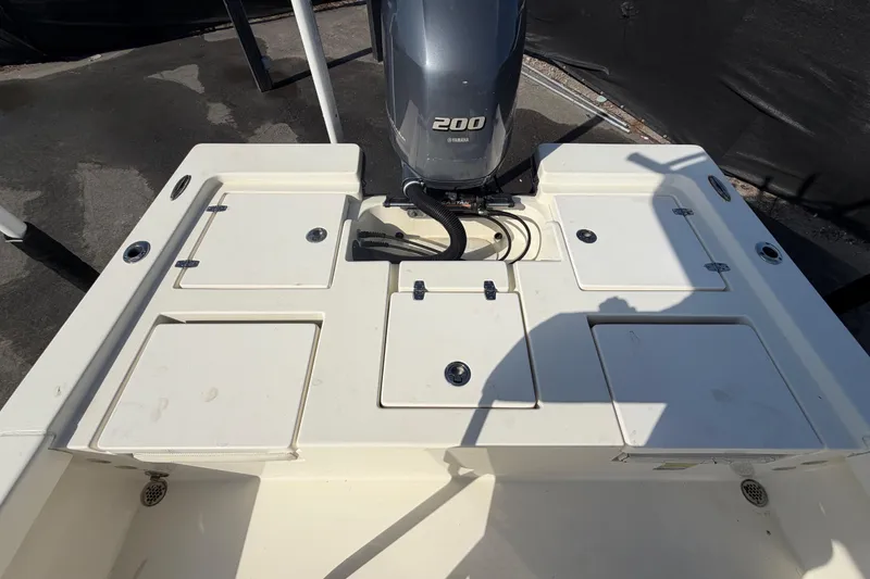 Slide: The Image of 2015 Pathfinder 2200 TRS boat deck with storage compartment and engine components. - 69