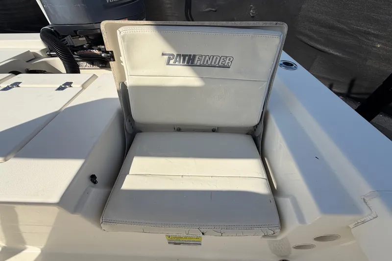 Slide: The Image of Trailer wheels of a 2015 Pathfinder 2200 TRS on asphalt, supported by a wooden block. - 73