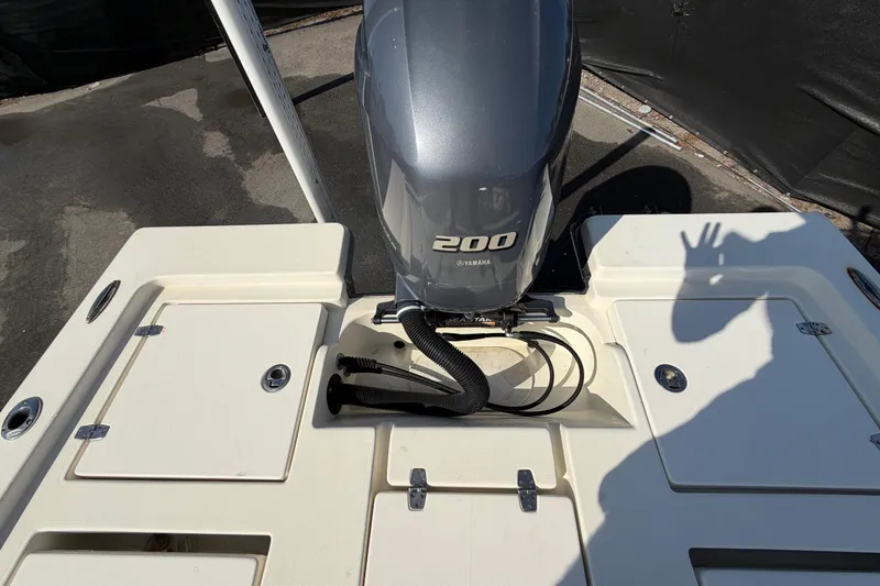 Slide: The Image of Trailer wheels of a 2015 Pathfinder 2200 TRS boat on pavement. - 74