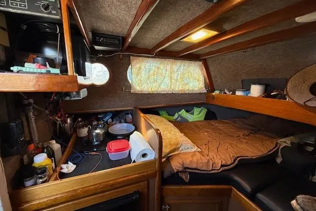 Slide: The Image of Cozy interior of 1982 Willard Vega 30 boat with bed and kitchenette. - 11
