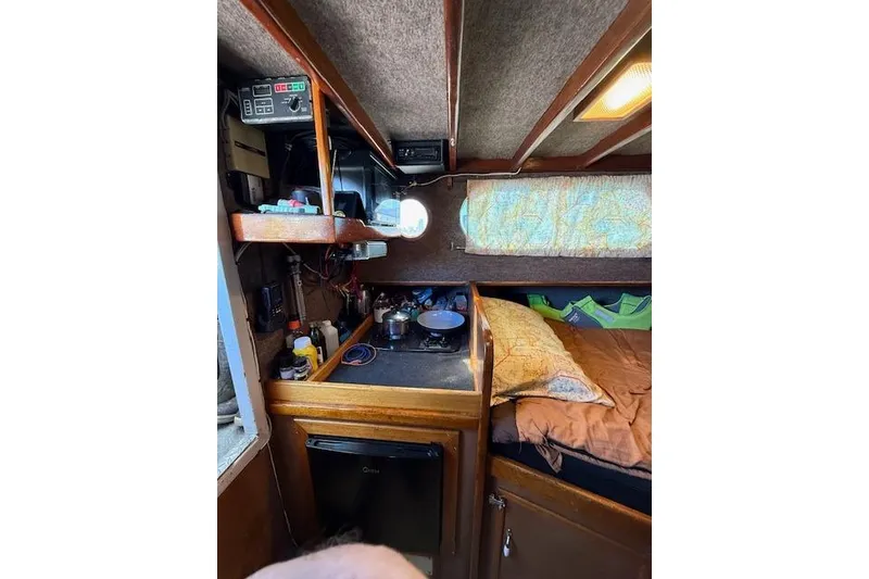 Slide: The Image of Cozy interior of 1982 Willard Vega 30 boat with kitchenette and sleeping area. - 13