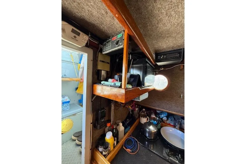 Slide: The Image of Interior of 1982 Willard Vega 30 boat with wooden shelves and nautical equipment. - 14