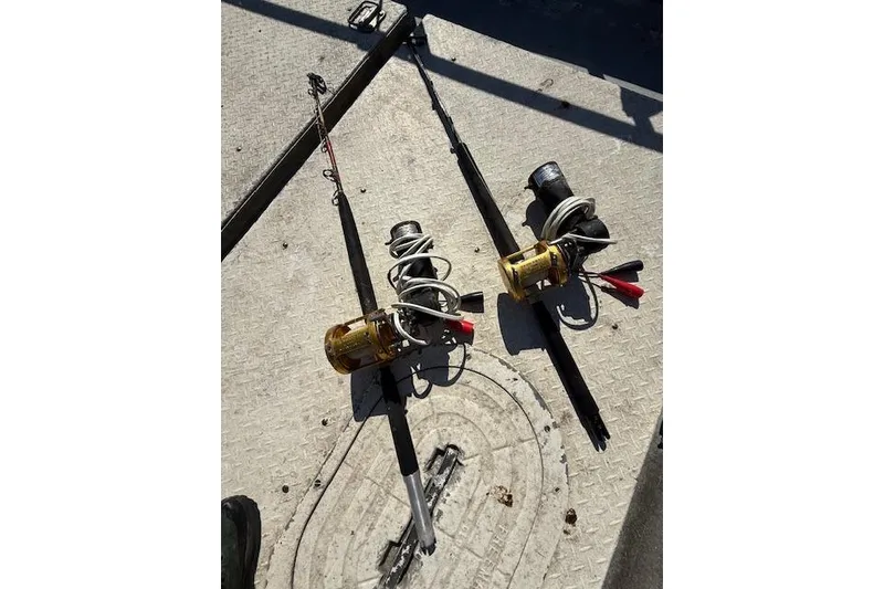 Slide: The Image of Two fishing rods with reels on a boat deck, Willard Vega 30, 1982 model. - 16