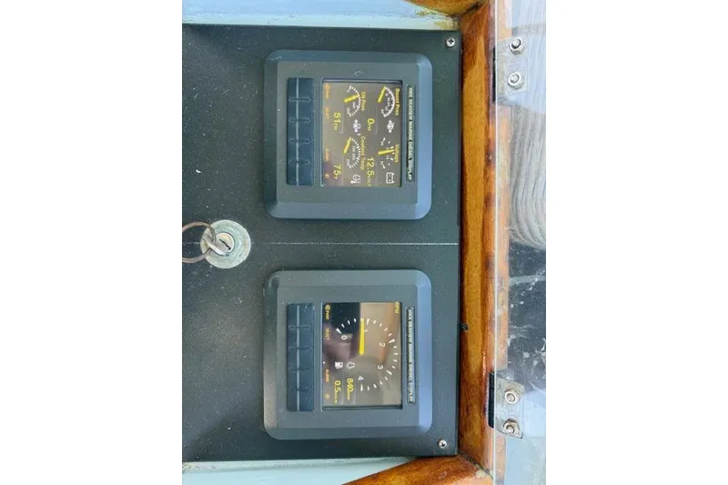 Slide: The Image of Control panel of a 1982 Willard Vega 30 boat with gauges and key. - 17