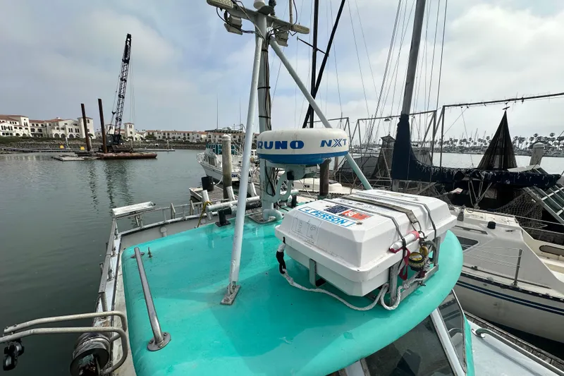 Slide: The Image of 1982 Vega Marine 30 boat docked at a marina, surrounded by other vessels. - 22