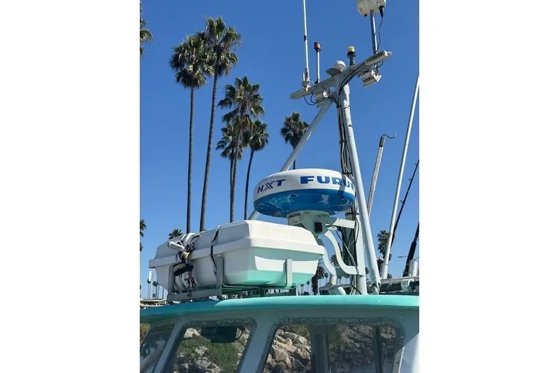 Slide: The Image of 1982 Willard Vega 30 boat with radar equipment, palm trees in background. - 3