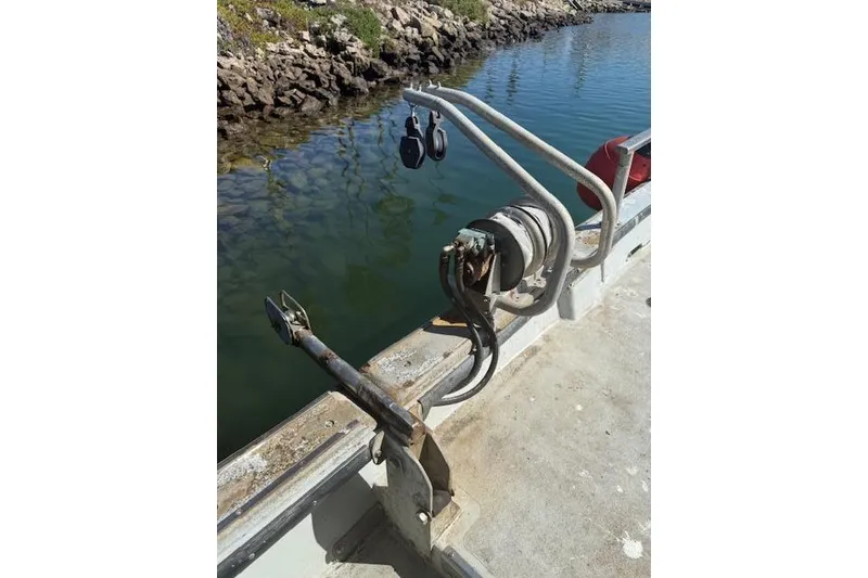 Slide: The Image of Boat deck with anchor winch, railing, and calm water reflection; Willard Vega 30, 1982 model. - 5
