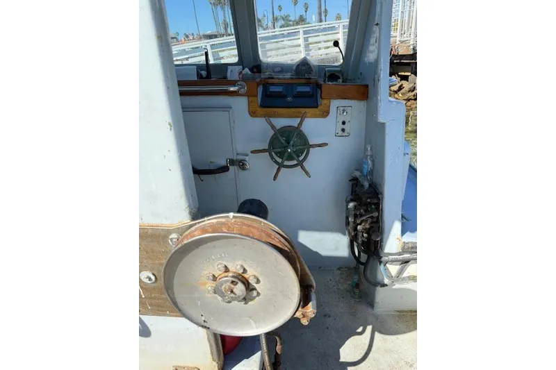 Slide: The Image of Interior of a 1982 Willard Vega 30 boat, featuring steering wheel and control panel. - 8