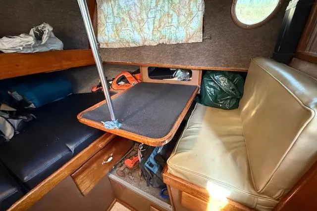 Slide: The Image of 1982 Willard Vega 30 cabin interior with seating, table, and storage. - 9