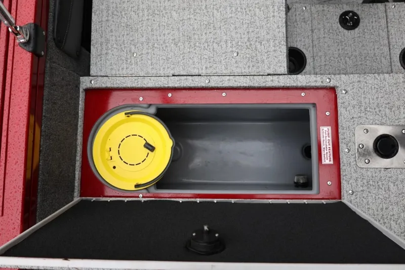 Slide: The Image of 2022 Tracker Targa V-19 Combo Tournament Edition boat storage compartment with yellow bucket. - 21