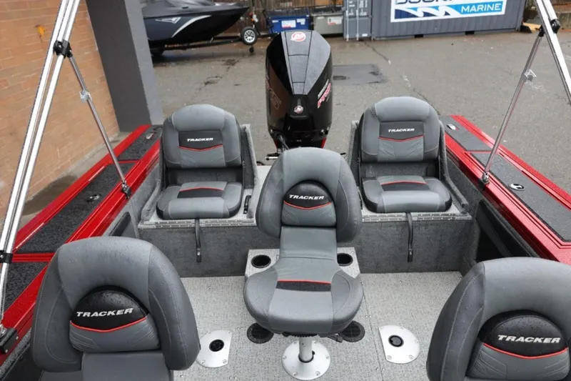 Slide: The Image of 2022 Tracker Targa V-19 Combo Tournament Edition boat interior with seating and motor. - 26