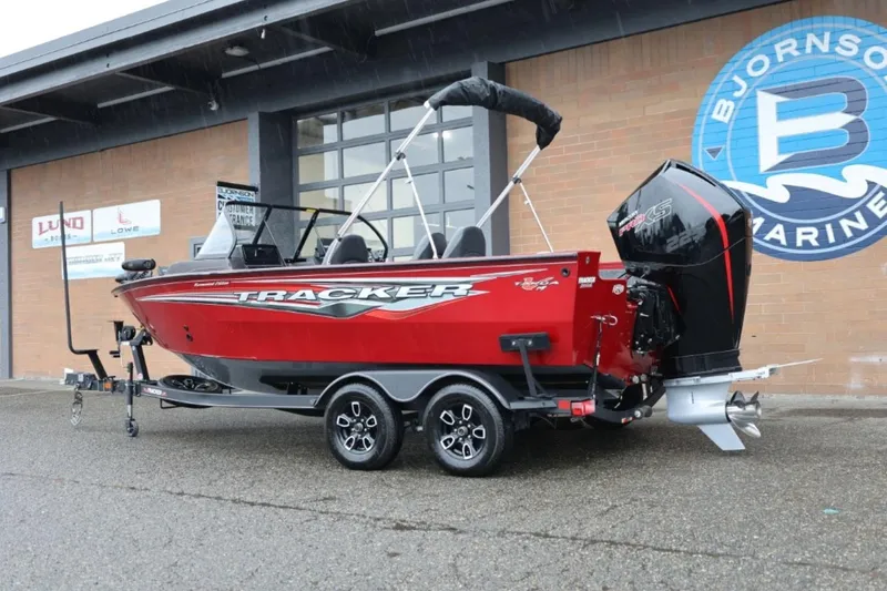 Slide: The Image of 2022 Tracker Targa V-19 Combo Tournament Edition boat in red, parked outside Bjornson Marine. - 4