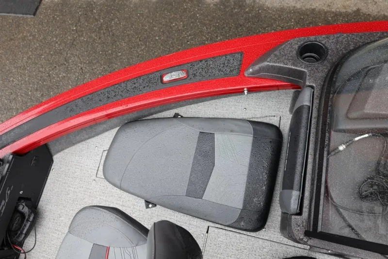 Slide: The Image of 2022 Tracker Targa V-19 Combo Tournament Edition boat interior with red accents and seating. - 54