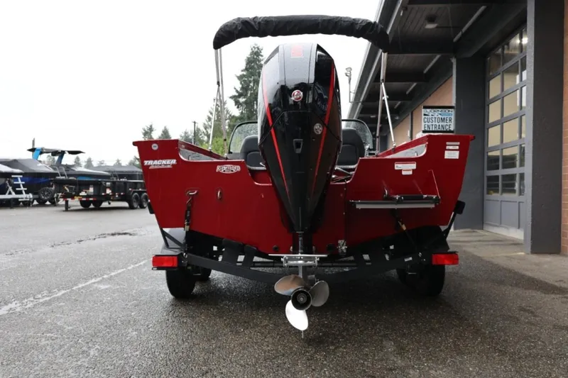 Slide: The Image of 2022 Tracker Targa V-19 Combo Tournament Edition boat, rear view, parked outside dealership. - 6